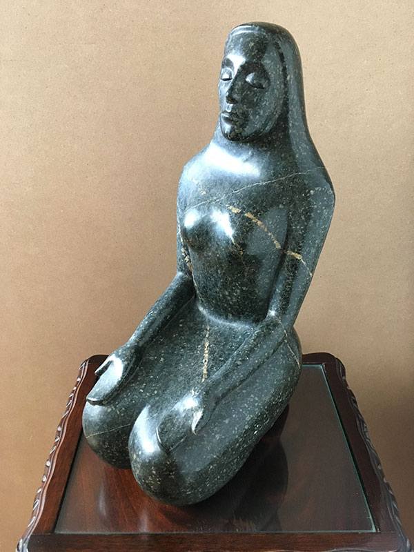 Woodcarving of a meditating woman