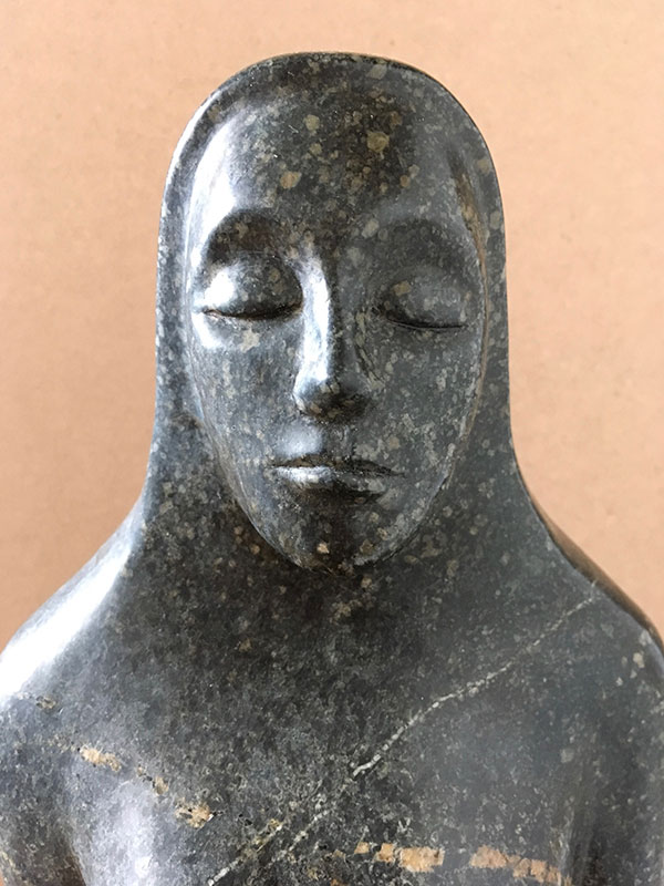 Woodcarving of a meditating woman